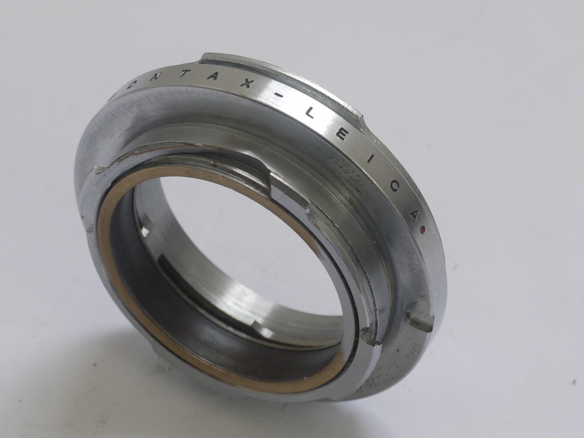 Unamed, high quality made Contax lens to Leica M mount adapter, chrome, 6-bit, with rangefinder coupling helicoid. Scale in meters & feet Unamed, high quality made Contax lens to Leica M mount adapter, chrome, 6-bit, with rangefinder coupling helicoid. Scale in meters & feet. Has internal & External mount for all Contax & Nikob S rangefinder lenses