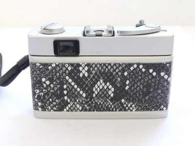 Konica C35 35mm coupled rangefinder camera with 38mm f2.8 Hexanon lens & wrist strap. Re-skinned with faux snakeskin covering