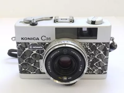 Konica C35 35mm coupled rangefinder camera with 38mm f2.8 Hexanon lens & wrist strap. Re-skinned with faux snakeskin covering
