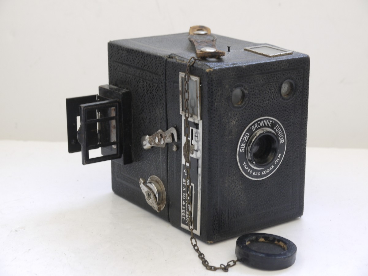 mwclassiccameras-20210716-277 Kodak Six-20 Brownie Junior leatherette covered Box camera, all plain, with added side mounting sports finder & front cap on a chain with metallic Art-Deco patterned front c1934-42. No handle