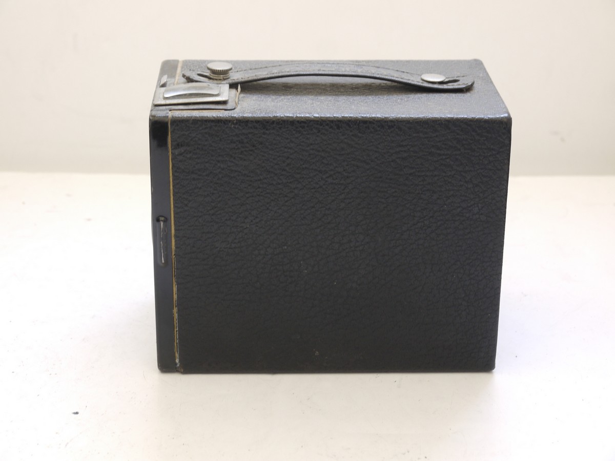 mwclassiccameras-20210716-315 Kodak Brownie Target Six-20 leatherette covered Box camera with metallic Vertcal striped Art-Deco patterned front c1946-52. With handle