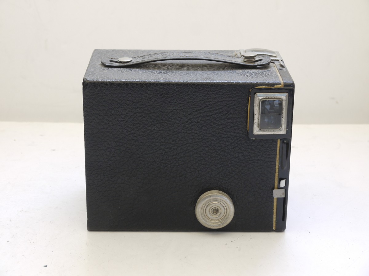 mwclassiccameras-20210716-317 Kodak Brownie Target Six-20 leatherette covered Box camera with metallic Vertcal striped Art-Deco patterned front c1946-52. With handle