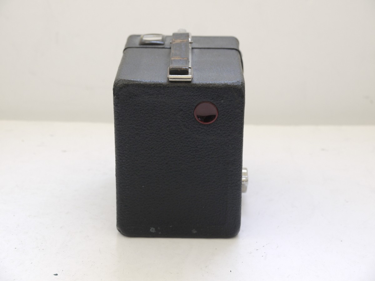 mwclassiccameras-20210716-332 Kodak Six-20 Brownie (UK Type) metal box camera c1930s with Vertical Striped Art-Deco front with Close-Up Portrait setting. With hadle