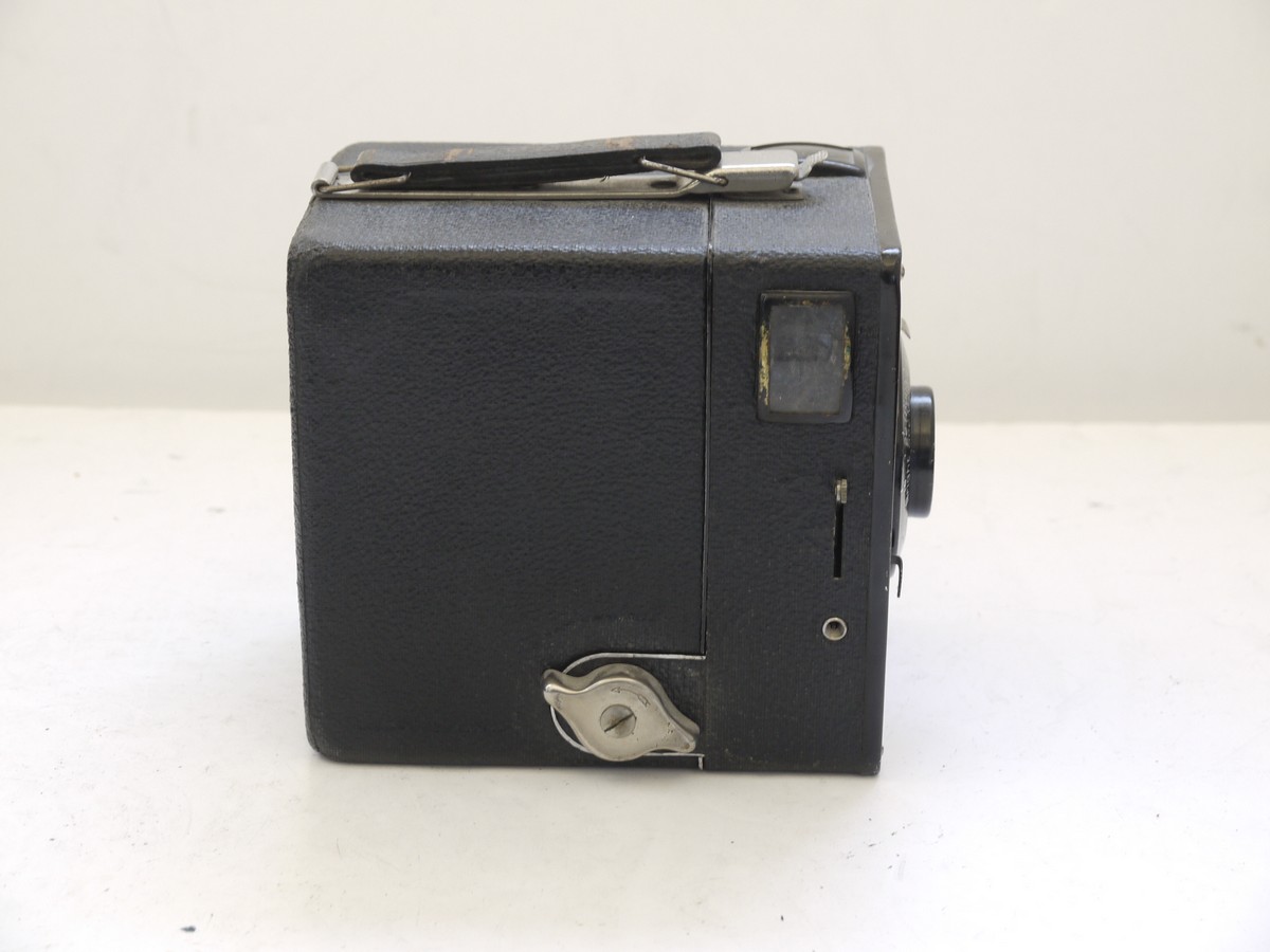mwclassiccameras-20210716-333 Kodak Six-20 Brownie (UK Type) metal box camera c1930s with Vertical Striped Art-Deco front with Close-Up Portrait setting. With hadle