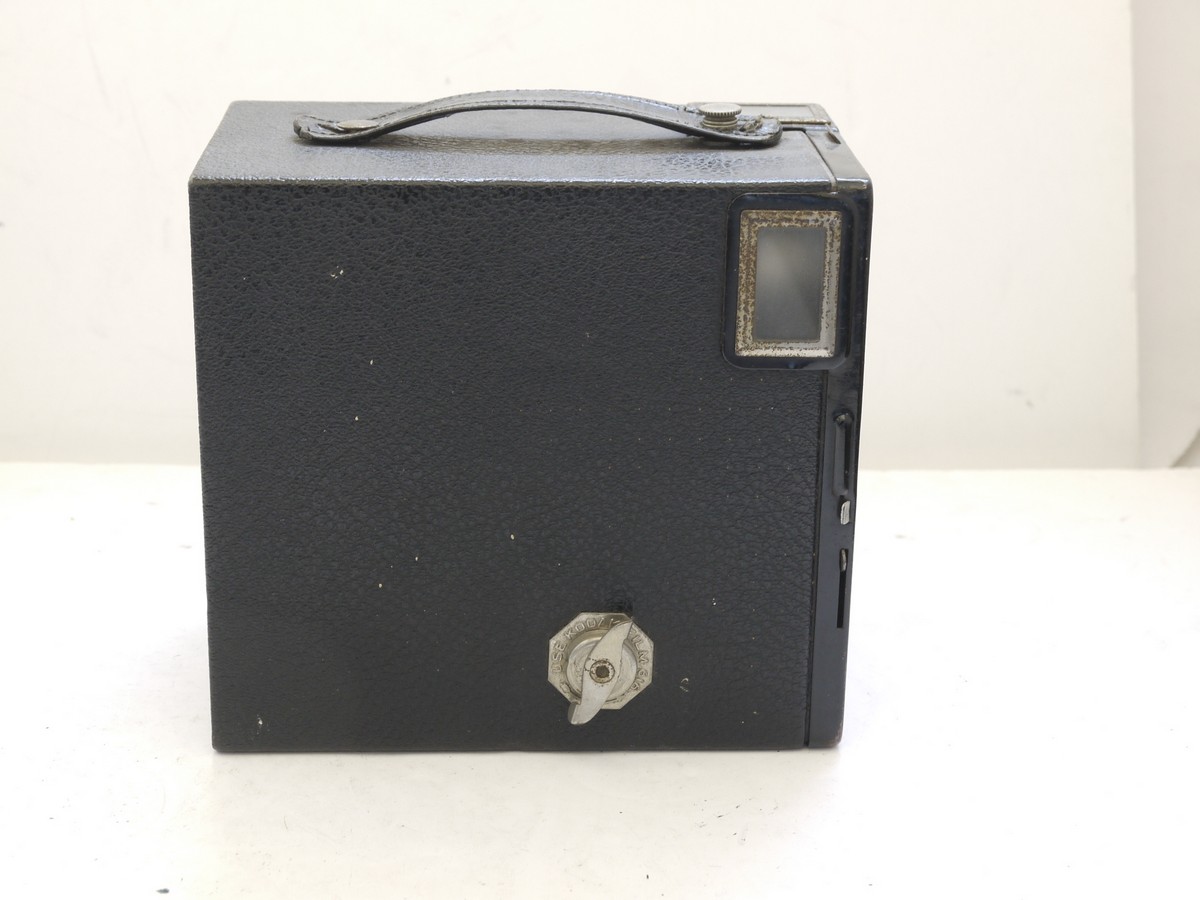mwclassiccameras-20210716-337 Kodak Six-16 Brownie Junior cardboard Box camera with metallic Art-Deco patterned front c1934-42. With handle