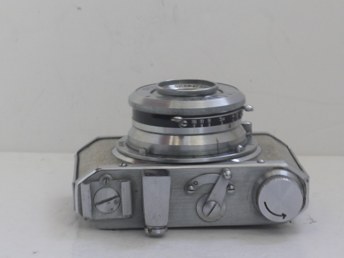 mwclassiccameras-20211112-39 Silver Gelto DIII 127 rigid body all metal camera with textured patterning, with 5cm f3.5 Grimmel extending lens.