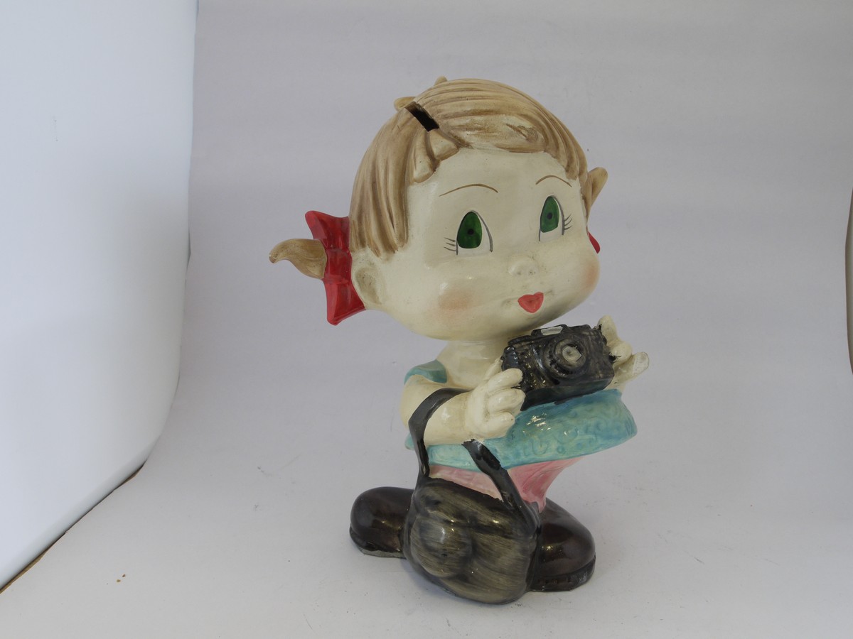 mwclassiccameras-20220415-303 Ceramic Figure/Moneybox of a Young Girl holding a camera & bag. Stands 210mm High