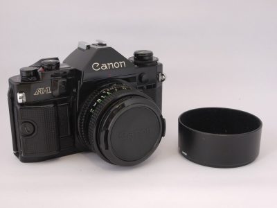 Canon A-1 35mm SLR + 50mm f1.8 FD lens, BS-52 bayonet lens hood & makers front lens cap