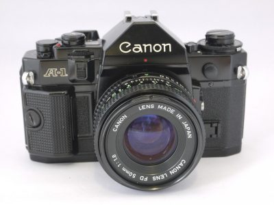 Canon A-1 35mm SLR + 50mm f1.8 FD lens, BS-52 bayonet lens hood & makers front lens cap