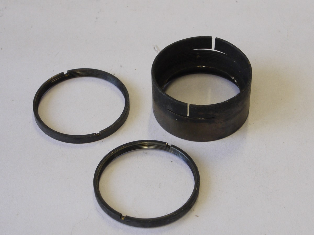 mwclassiccameras-20220610-372 Leitz Spare parts - Leica III/IIIa/IIIb body shell with vulcanite covering & 2 added front body flash sockets + Glass elements for the 50mm f3.5 Elmar nickel lens & the inner barrel & front face with some inner parts & with tIris Diaphragm