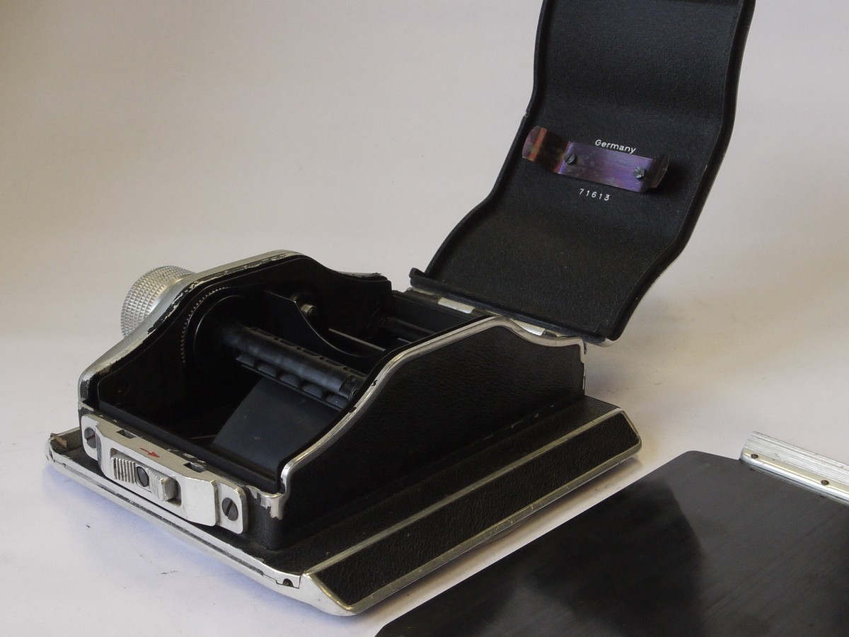 mwclassiccameras-20220708-76 Linhof Rollex 6x9 rotating rollfilm back, for 5x4, black covering, with dark slide. Name embossed on rear covering