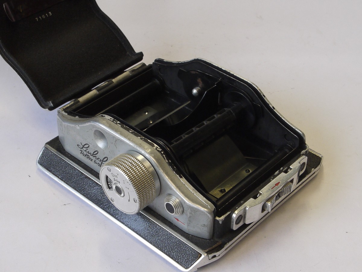 mwclassiccameras-20220708-77 Linhof Rollex 6x9 rotating rollfilm back, for 5x4, black covering, with dark slide. Name embossed on rear covering