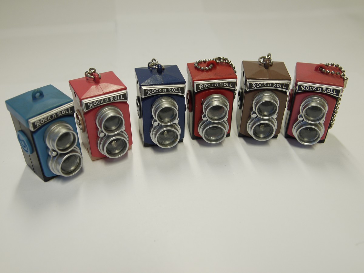 mwclassiccameras-20221014-330 Rock n Roll set of Six different multi-coloured Rolleiflex TLR Keyrings. Flashes when button pressed (Only 2 flashes are working)