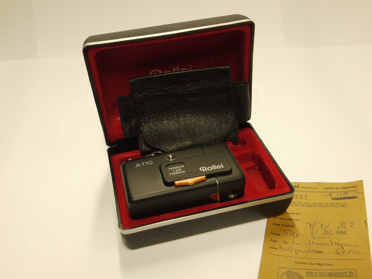mwclassiccameras-20221118-302 Rollei A110 Subminiature camera with 23mm f2.8 Tessar lens, Chain strap, Warranty papers, leatherette case & presentation case