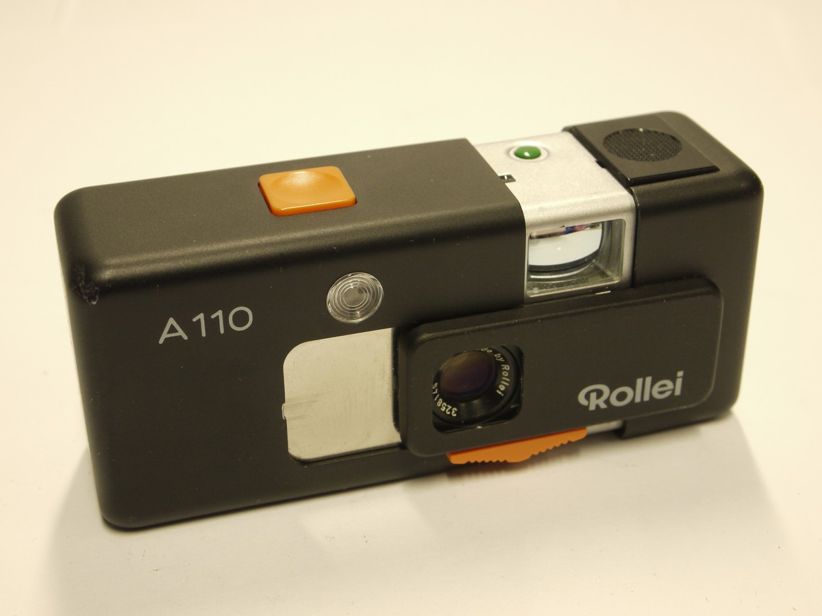 mwclassiccameras-20221118-308 Rollei A110 Subminiature camera with 23mm f2.8 Tessar lens, Chain strap, Warranty papers, leatherette case & presentation case