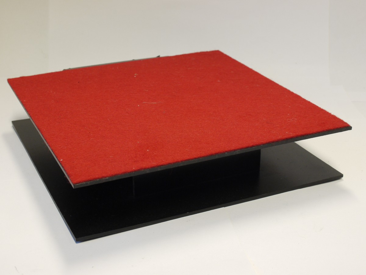 mwclassiccameras-20221223-212 Pentax Black plastic Display Stand, Square shaped with Red felt top & curved front. 210mm x 210mm x 43mm