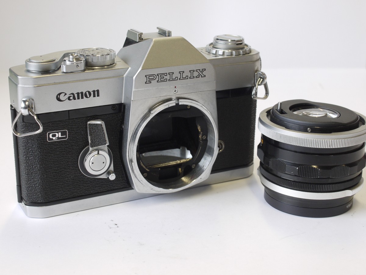 mwclassiccameras-20230414-148 Canon Pellix 35mm SLR, chrome, April 1965 + Canon 50mm f1.8 FL brreechlock mount lens with 48mm Skylight filter. Features through-the-mirror mechanism with mirror not rising when taking pictures