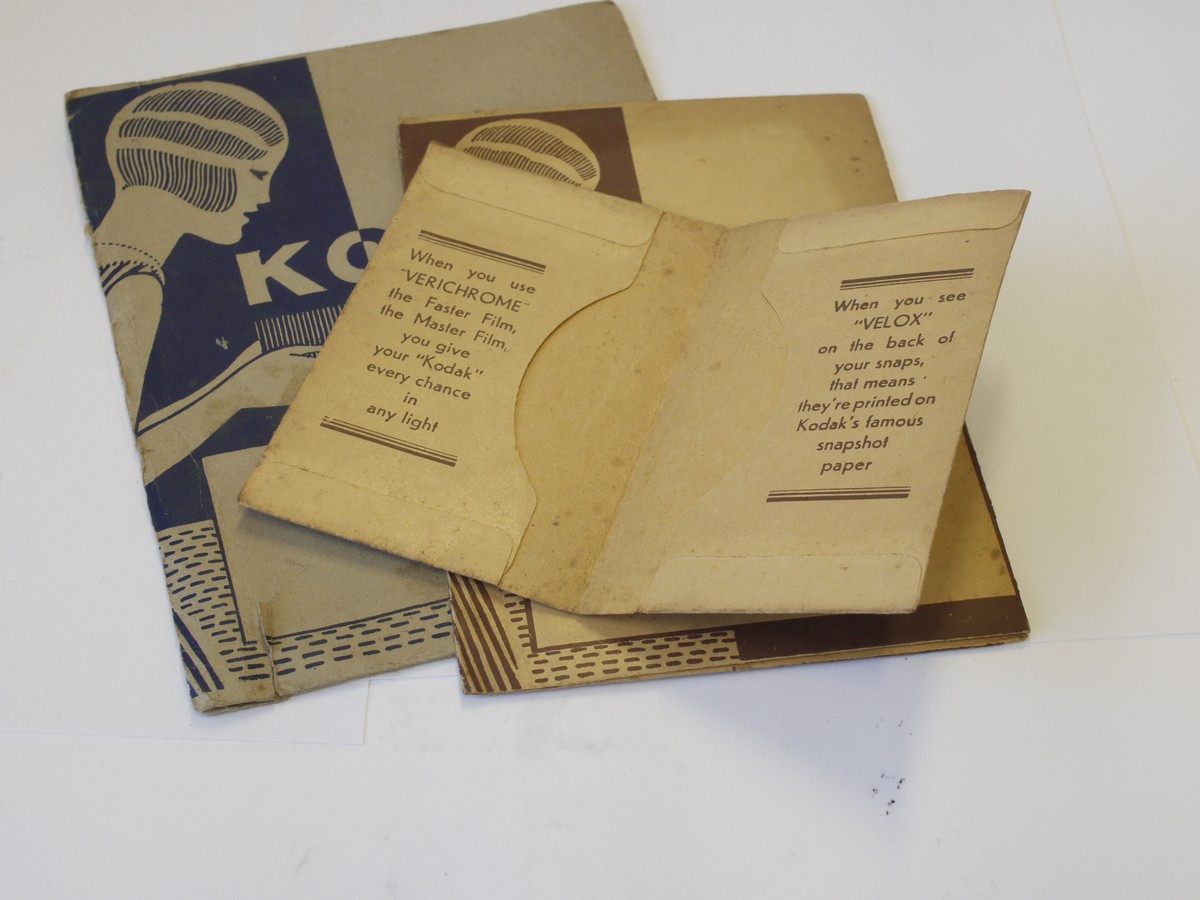 mwclassiccameras-20230526-333 Kodak Film Wallets - set of Three antique paper/card wallets for negatives with front images of woman holding an early box camera