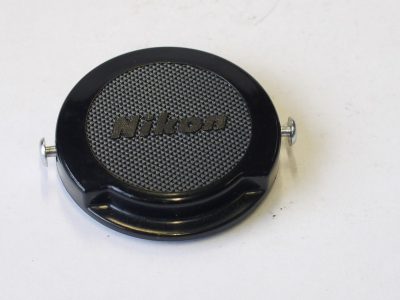Nikon 34.5mm clip-on black metal front lens cap, with metal "ear" clips