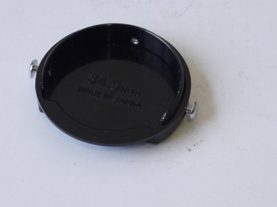Nikon 34.5mm clip-on black metal front lens cap, with metal "ear" clips