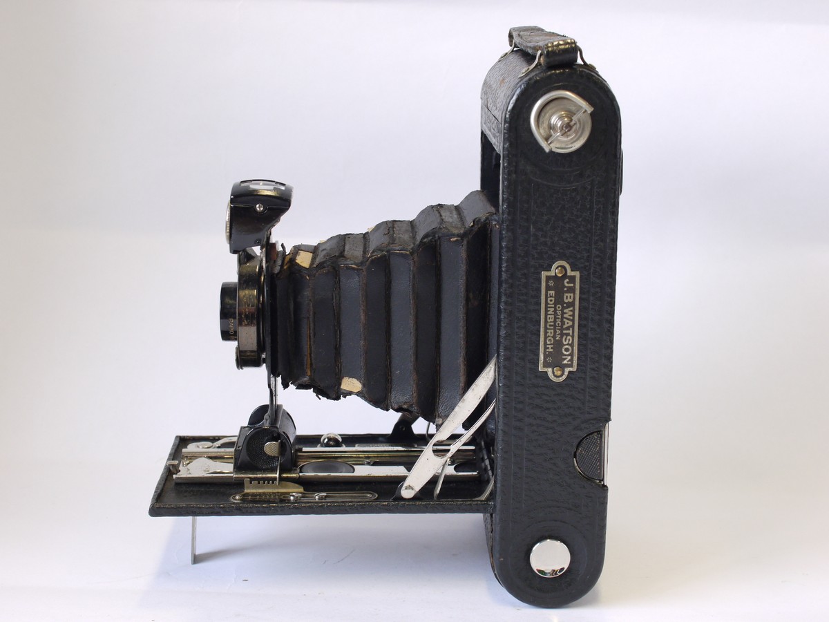 mwclassiccameras-20230908-48 Kodak No.1A Autographic Jr folding camera, all black, with Bausch & Lomb Rapid Rectilinear lens + leather case. With JB Watson name badge