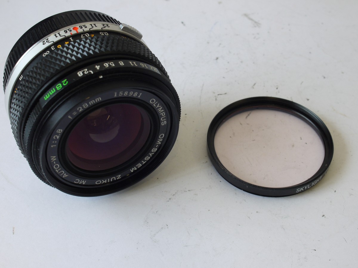 mwclassiccameras-20231006-158 Olympus 28mm f2.8 Zuiko Auto-W Manual focus OM mount lens + Skylight 1B filter & rear cap
