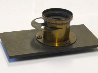 Unamed 1 1/2 -2 inch (Estimated) brass lens with rotating wheel aperture, flange & metal panel (Panel is 100 x 52mm)