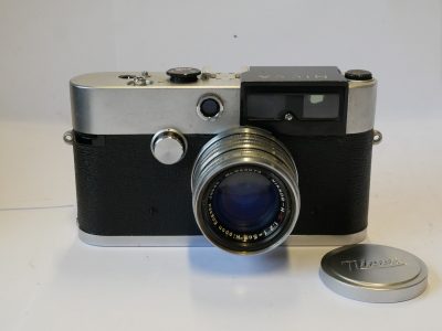 Nicca IIIL Leica Copy, late type (No.184053) c1958-59 with Nicca YF type black handle lever advance, with hinging back door + Nippon Kogaku 5cm f2 Nikkor-H.C coated chrome rigd type lens with Nicca ftont cap.UNCOMMON INTRMEDIATE MODEL. Nicca IIIL has production of approxiamtely 2000
