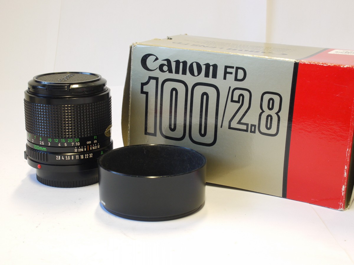 mwclassiccameras-20240119-301 Canon 100mm f2.8 manual focus FD mount lens + Canon caps. Canon BS-52 les hood, Instructions, wrranty caprd & box with packaging