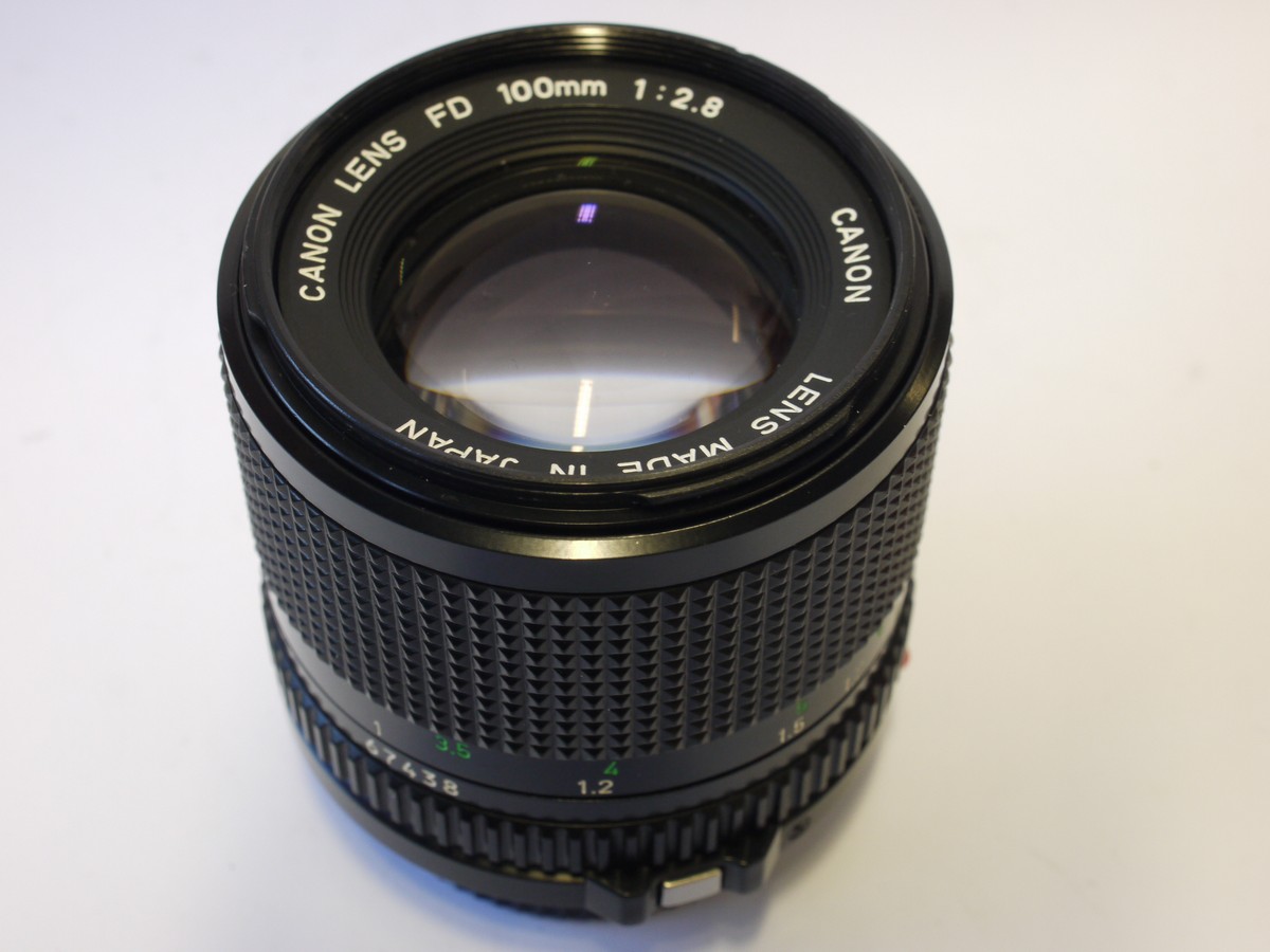 mwclassiccameras-20240119-304 Canon 100mm f2.8 manual focus FD mount lens + Canon caps. Canon BS-52 les hood, Instructions, wrranty caprd & box with packaging