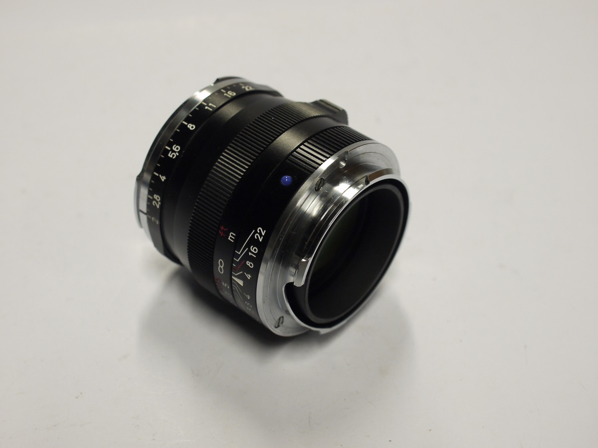 mwclassiccameras-20240126-542 Carl Zeiss 50mm f2 Planar T* ZM lens, black, Leica M RF mount + Kenko filter protector, In dependent made metal lens hoos with venbts, Leica Rear Cap & Zeiss front lens cap