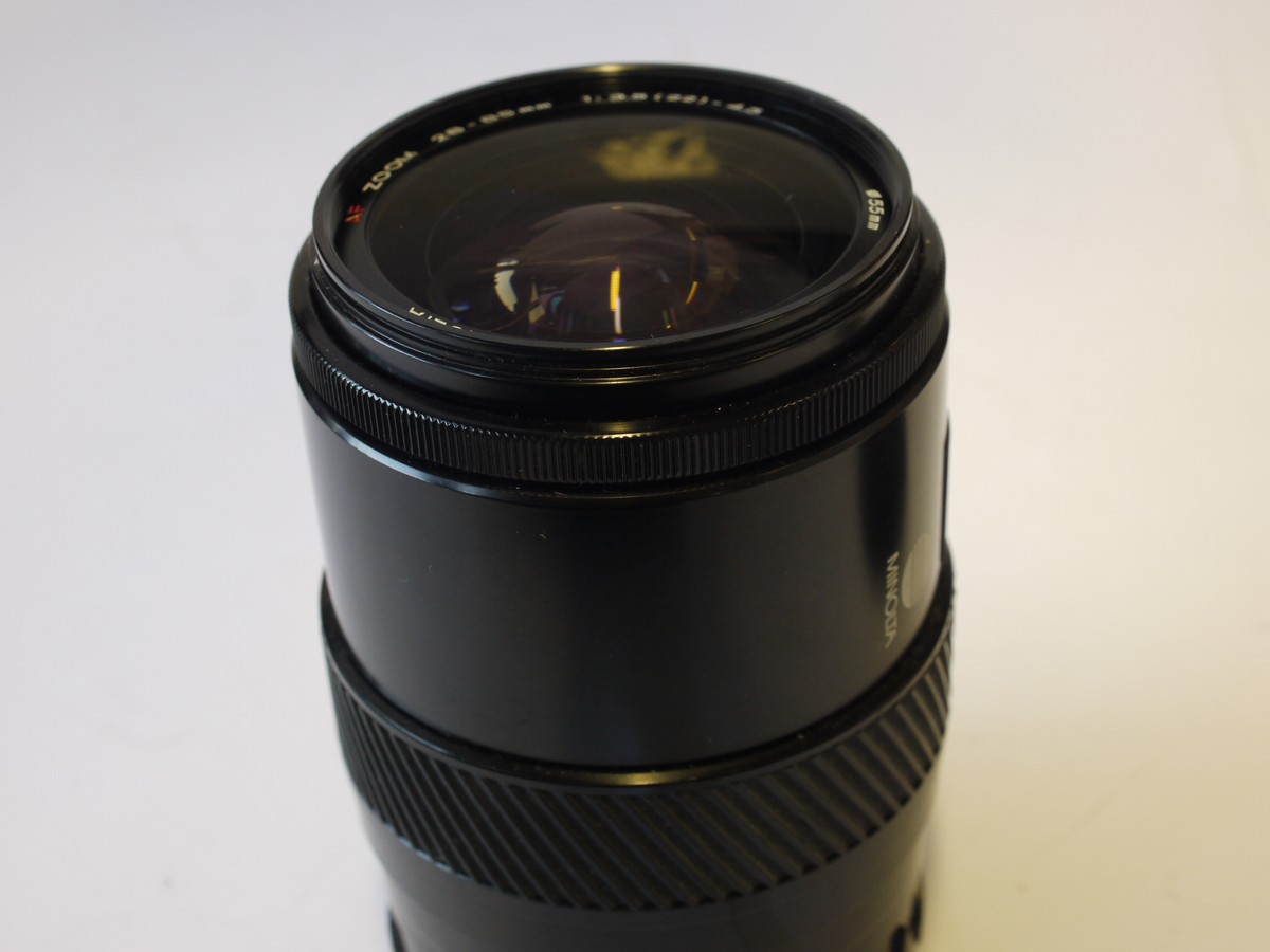 mwclassiccameras-202400202-75 Minolta 28-85mm f3.5-4.5 AF Zoom lens + Minolta Clip-on lens hood, Minolta Skylight 1B filter & caps