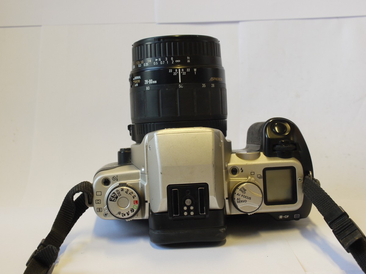 mwclassiccameras-20240216-295 Canon EOS 50E 35mm AF SLR, Black & Grey coloured + Sigma 28-80mm f3.5-5.6 Zoom ens, with front cap, instructions & Canon neck strap