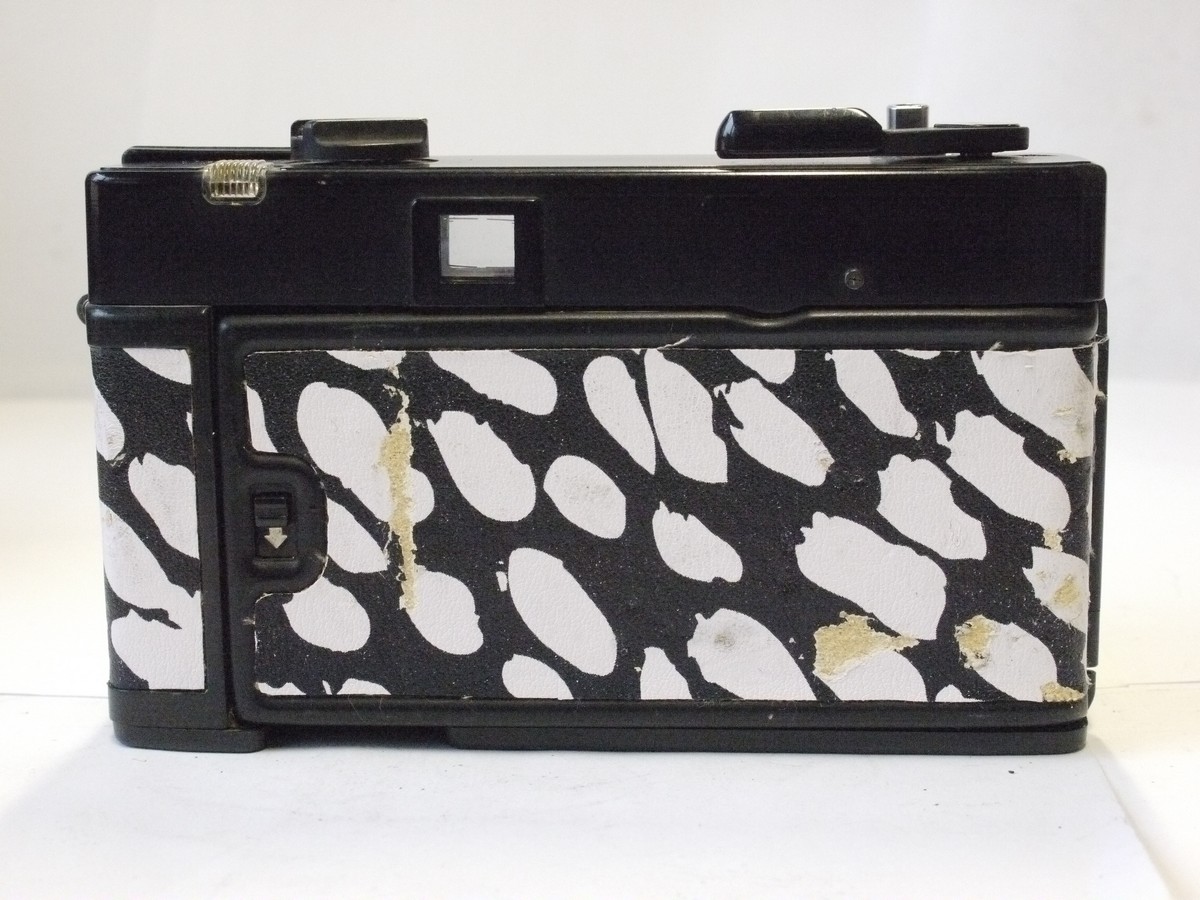 mwclassiccameras-20240229-58 Konica C35 ASF-P 35mm fixed-focus point-& shoot camera with pop-up flash & 38mm f4 HexaNON LENS. Re-skinned in black & white dalmation dog skin effect