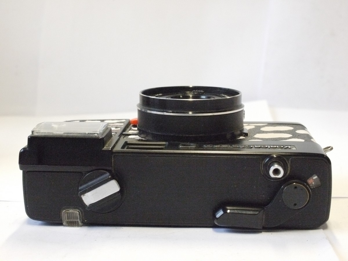 mwclassiccameras-20240229-59 Konica C35 ASF-P 35mm fixed-focus point-& shoot camera with pop-up flash & 38mm f4 HexaNON LENS. Re-skinned in black & white dalmation dog skin effect