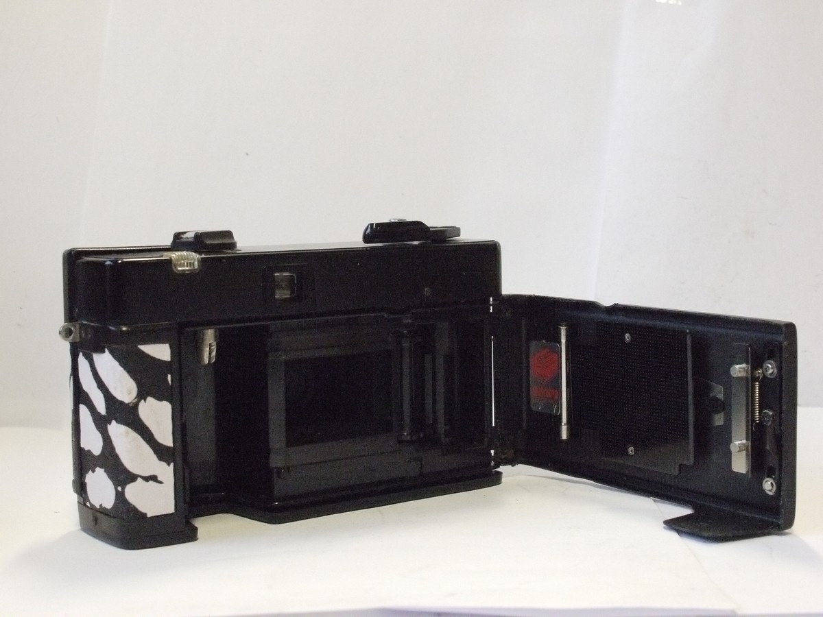 mwclassiccameras-20240229-61 Konica C35 ASF-P 35mm fixed-focus point-& shoot camera with pop-up flash & 38mm f4 HexaNON LENS. Re-skinned in black & white dalmation dog skin effect