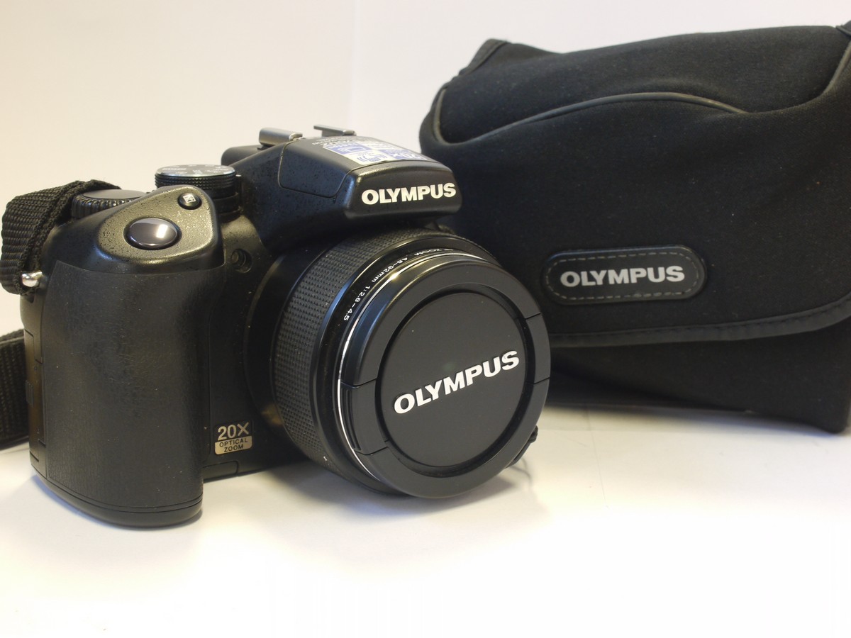 mwclassiccameras-20240315-95 Olympus SP-57OUZ 10 MP Bridge Camera, black, with 4.6-92mm f2.8-4.5 ED AFZoom lens + front cap, neck strap & case. Takes AA Batteries