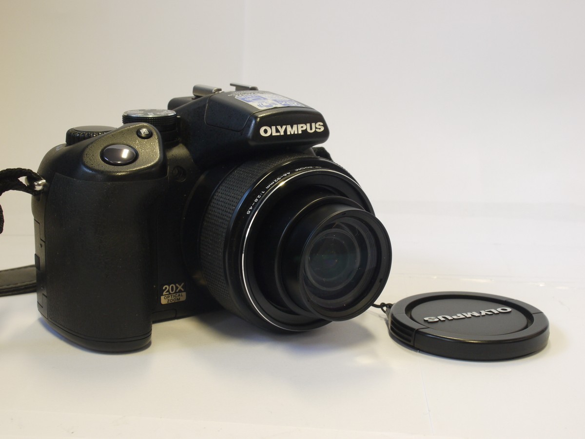 mwclassiccameras-20240315-96 Olympus SP-57OUZ 10 MP Bridge Camera, black, with 4.6-92mm f2.8-4.5 ED AFZoom lens + front cap, neck strap & case. Takes AA Batteries