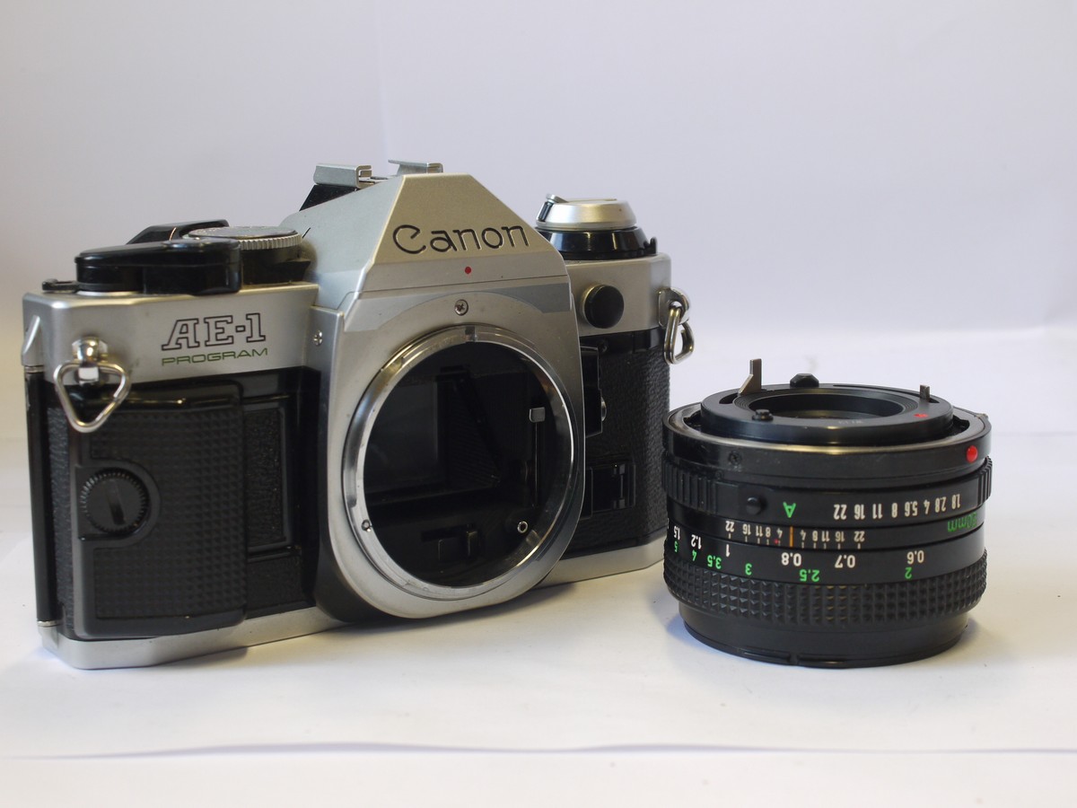 mwclassiccameras-20240405-121 Canon AE-1 Program 35mm SLR, chrome with hand grip + Canon 50mm f1.8 FD lens & Original Instructions