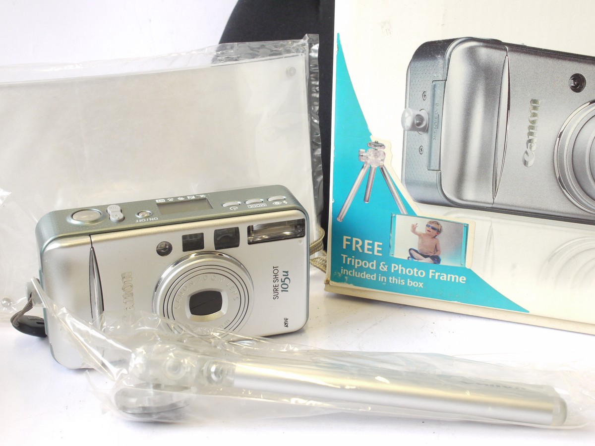 mwclassiccameras-20240712-156 Canon Sureshot 105u 35mm Compact Autofocus Point-&- Shoot camera, Silver coloured, with 38-105mm Zoom, wrist trap, Instructions, Acrylic Photo Frame & makers Box