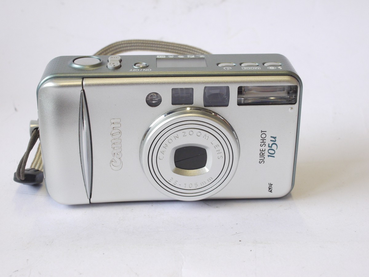 mwclassiccameras-20240712-157 Canon Sureshot 105u 35mm Compact Autofocus Point-&- Shoot camera, Silver coloured, with 38-105mm Zoom, wrist trap, Instructions, Acrylic Photo Frame & makers Box
