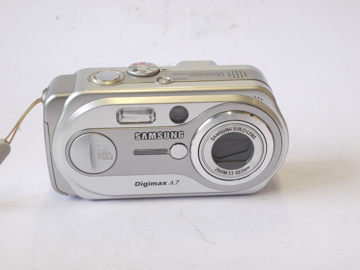 mwclassiccameras-20240712-63 Samsung Digimax A7 7MP Digital Compact Camera, Silver Coloured, with 7.7-23.1mm Zoom lens + wrist strap & Instructions. No Battery or Charger