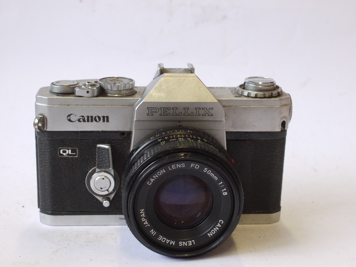 mwclassiccameras-20240719-141 Canon Pellix QL 35mm SLR, chrome + Canon 50mm f1.8 FD lens. Features through-the-mirror mechanism with mirror not rising when taking pictures. FOR RESTORATION/SPARE PARTS
