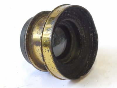 Photo-Port Paris 2-3 inch (Estimated) Grand Angle (Wide Angle) brass lens with rotating wheel apertures & scree-in brass lens hood. Lens engraved 8x12 (Coverage)