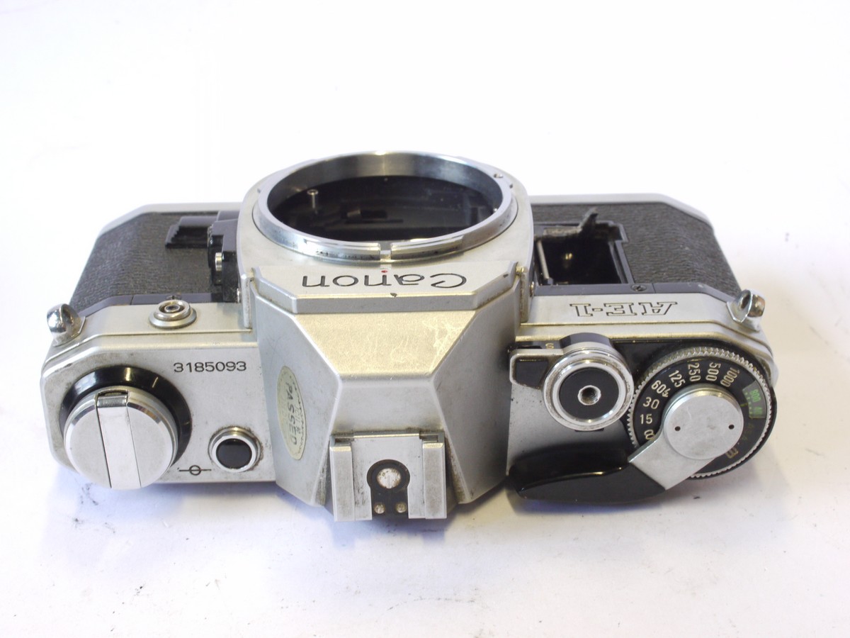 mwclassiccameras-20240816-42 Canon AE-1 35mm SLR body, chrome. Battery cover has broken off. UNTESTED