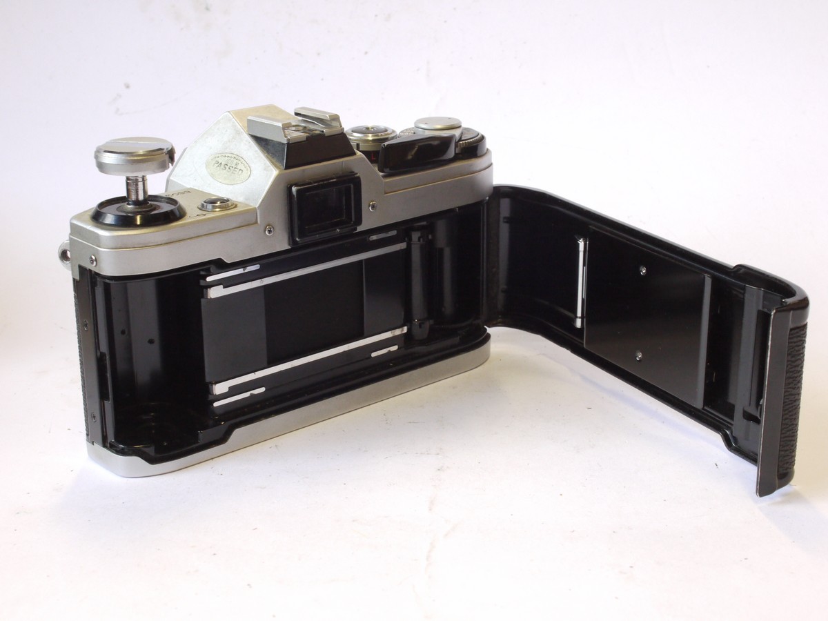 mwclassiccameras-20240816-44 Canon AE-1 35mm SLR body, chrome. Battery cover has broken off. UNTESTED