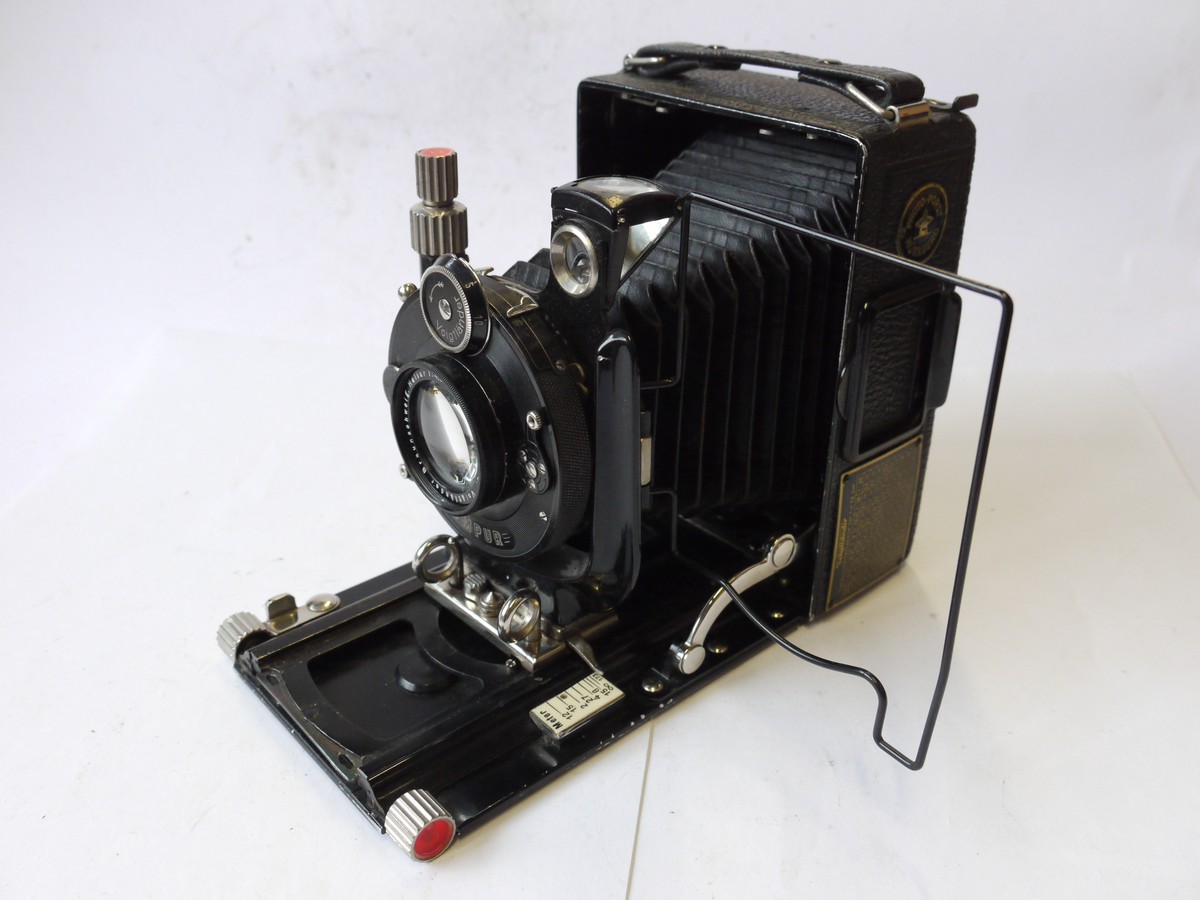 mwclassiccameras-20240927-300 Voigtlander Bergheil 6x9 folding plate camera, all black, with ground glass back & 12cm f4.5 Heliar interchangeable bayonet mount lens + leather case
