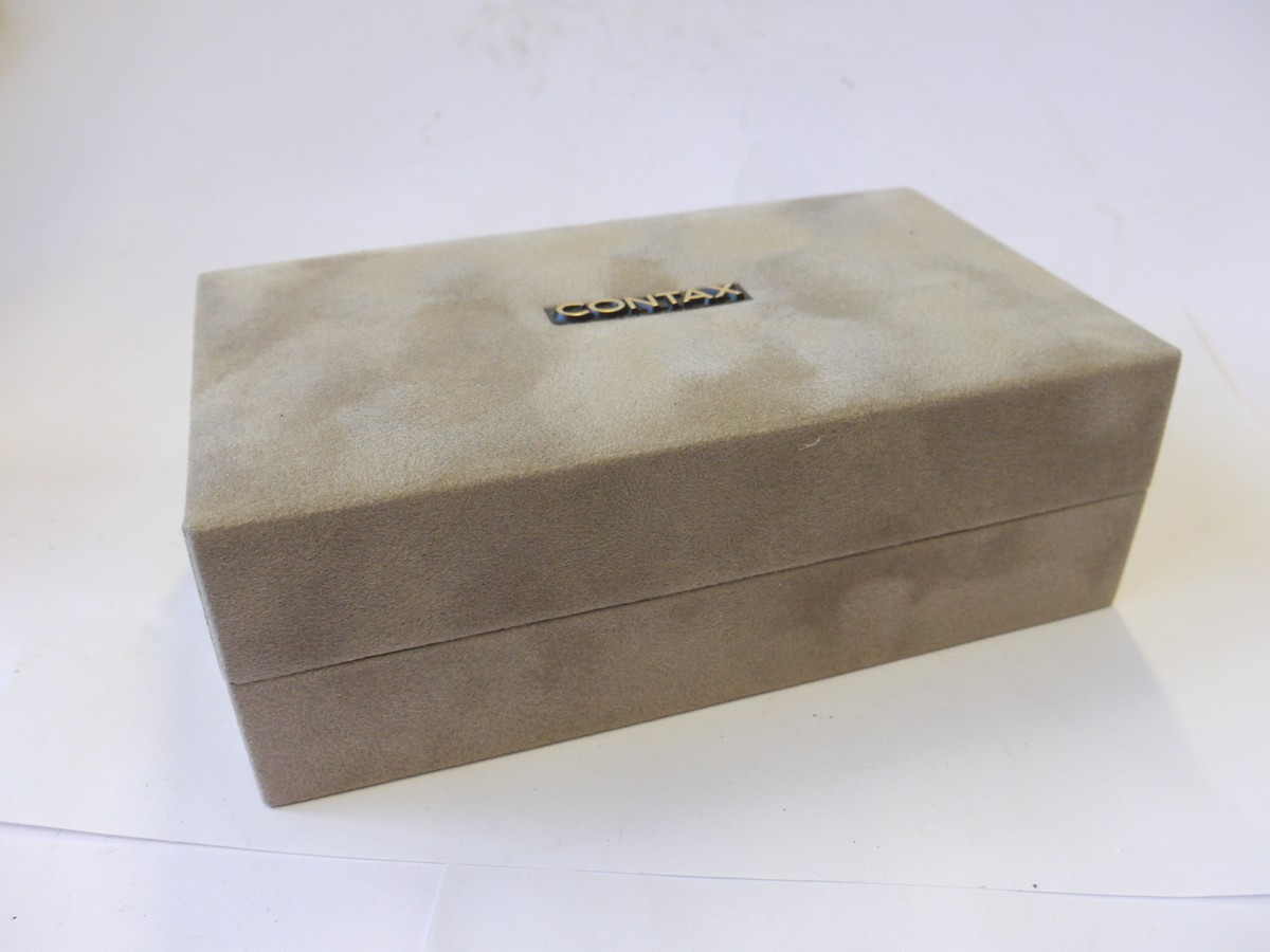mwclassiccameras-20241004-65 Contax T Silver coloured 35mm folding coupled rangefinder camera with 38mm f2.8 Sonnar T* lens + Original Instructions, Warranty card, Presentation box & outer box. UNCOMMON