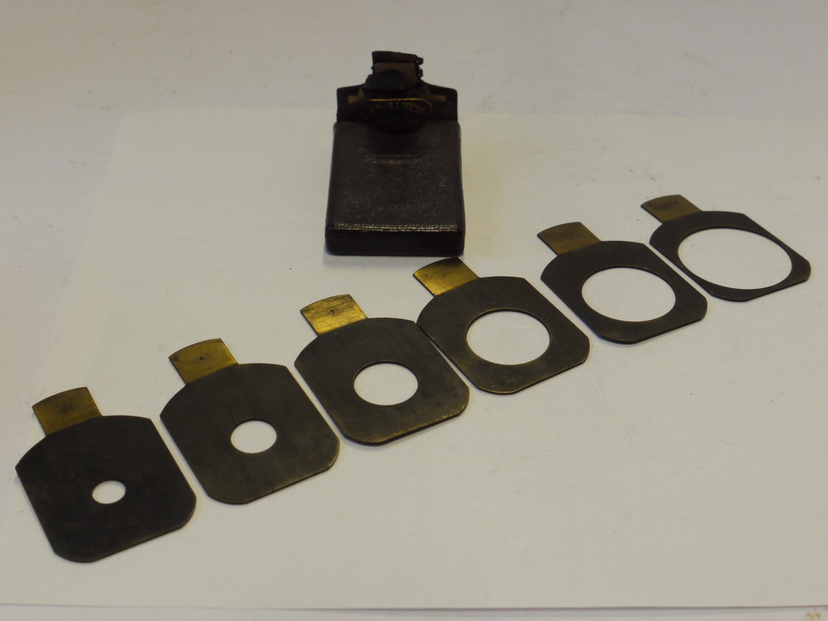 mwclassiccameras-20241129-72 Dallmeyer Waterhouse Stops set of Six Metal Stops, marked with serial number, *, 2, 3, 4 & 5 (43x35mm), with end handle grip & Dallmeyer Brown leather case