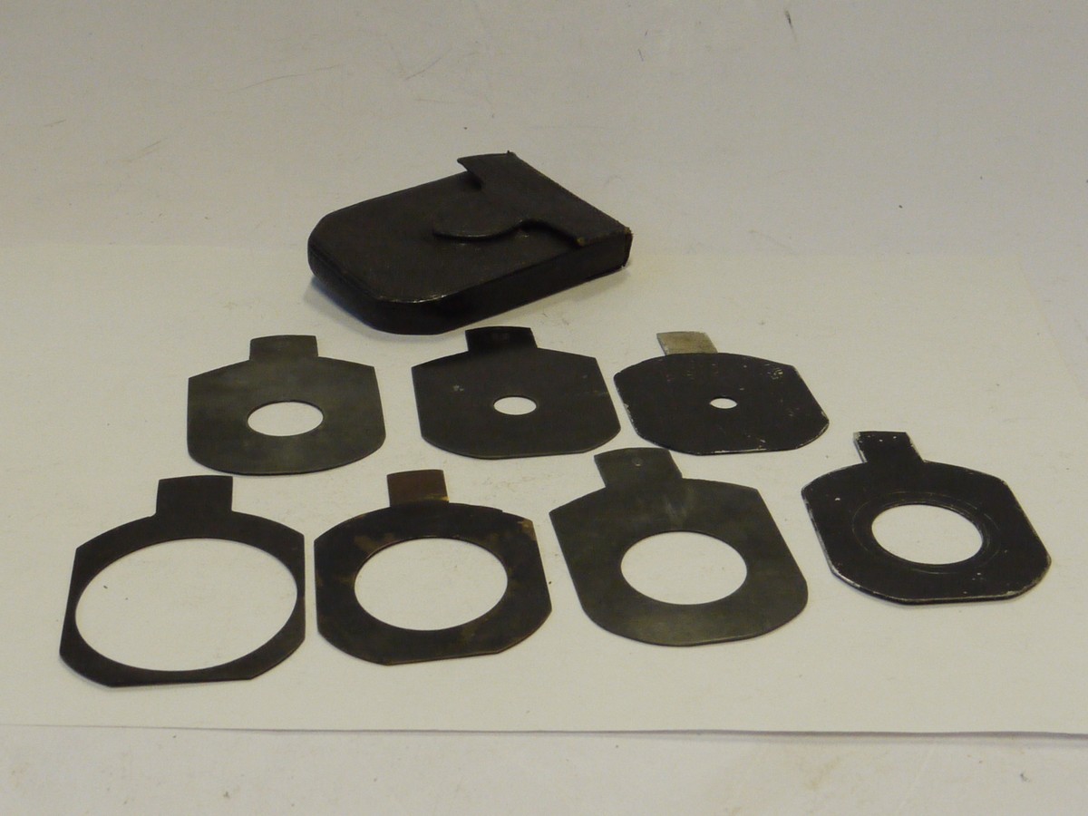 mwclassiccameras-20241129-87 Unamed Waterhouse stops Two sets of Metal Stops. Four stops marked f6, f8, f11 & f16 (60x47mm) + Unmaerked set of three different stops (54x48mm). All with end handle grips in one Green leather case
